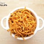 Besan sev is a very famous snack prepared in every household kitchen in India. It is a blend of besan or gram flour and a few spices, which is deep-fried. They are crisp and savory in taste and a great tea time snack. This snack is made during Holi or Diwali, though you can cook throughout the year
