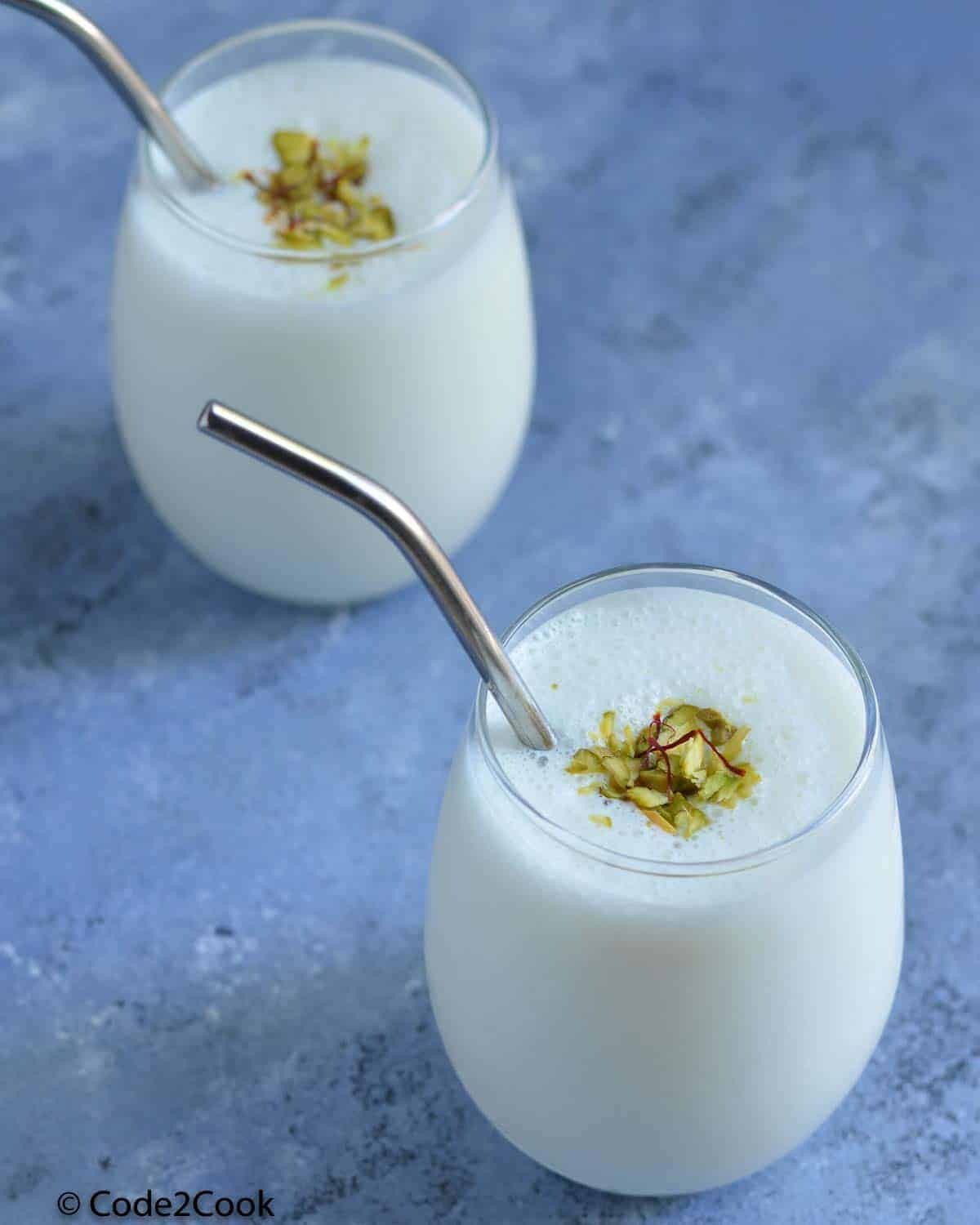 Lassi served in glasses, garnished with dry fruits