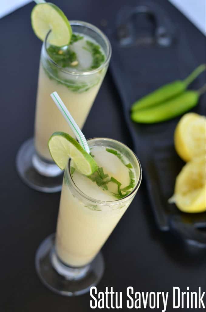 Sattu drink served in tall glass with lemon wedges.