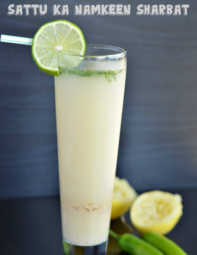 close up click of sattu drink, which is served in a tall glass with lemon wedge.