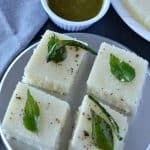 Rava dhokla is a fluffy and soft snack from Gujarat in India. Dhokla is a very popular dish from Gujarat, with many variations like besan dhokla, rava dhokla, dal dhokla, tiranga dhokla to name few. These take just 30 minutes to prepare and great for kid's tiffin box as well. Out of all varieties, besan or khaman dhokla and rava dhokla are the most popular ones.