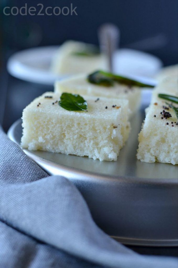 Rava dhokla is a fluffy and soft snack from Gujarat in India. Dhokla is a very popular dish from Gujarat, with many variations like besan dhokla, rava dhokla, dal dhokla, tiranga dhokla to name few. These take just 30 minutes to prepare and great for kid's tiffin box as well. Out of all varieties, besan or khaman dhokla and rava dhokla are the most popular ones.