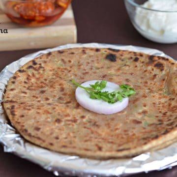 Mooli paratha or radish paratha is an Indian flatbread stuffed with grated radish. Stuffing is spiced up with few spices and then stuffed in whole wheat dough portions. These parathas make a wholesome meal for breakfast, lunch or dinner.