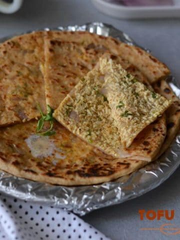 Tofu Paratha is another delicious paratha wherein scrambled tofu seasoned with coriander and few spices, stuffed in the whole wheat dough. Tofu paratha is high nutritional values. This paratha can be served in breakfast or snack, kids love these with curd.
