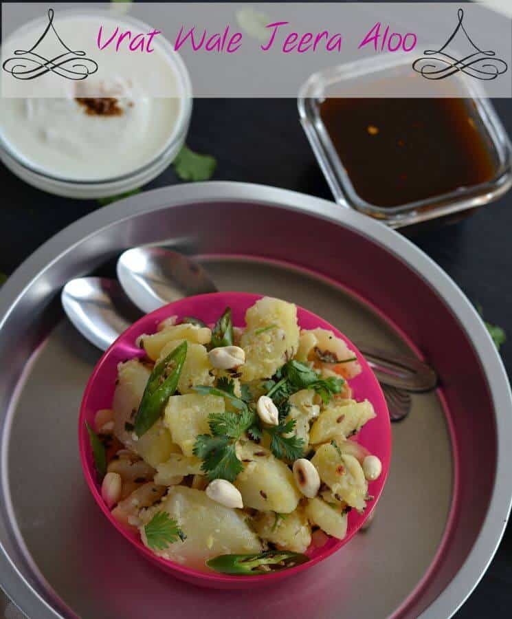 crispy aloo chaat is served in a pink bowl. Garnished with roasted peanuts, chilies & green coriander.tamarind chutney & curd is also served along with this.
