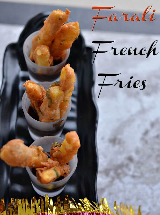 farali french fries served in mini glasses with chutney. Mini glasses are kept on black tray.