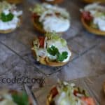 Mini taco salad canapes are perfect for the game day or kitty parties or kids after-school snack or as an appetizer. Filled with yummy avocado topped with chopped onion, tomato, sour cream, and lettuce, this snack is perfect to enjoy anytime.