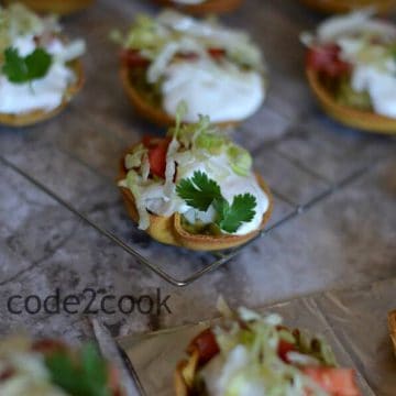 Mini taco salad canapes are perfect for the game day or kitty parties or kids after-school snack or as an appetizer. Filled with yummy avocado topped with chopped onion, tomato, sour cream, and lettuce, this snack is perfect to enjoy anytime.