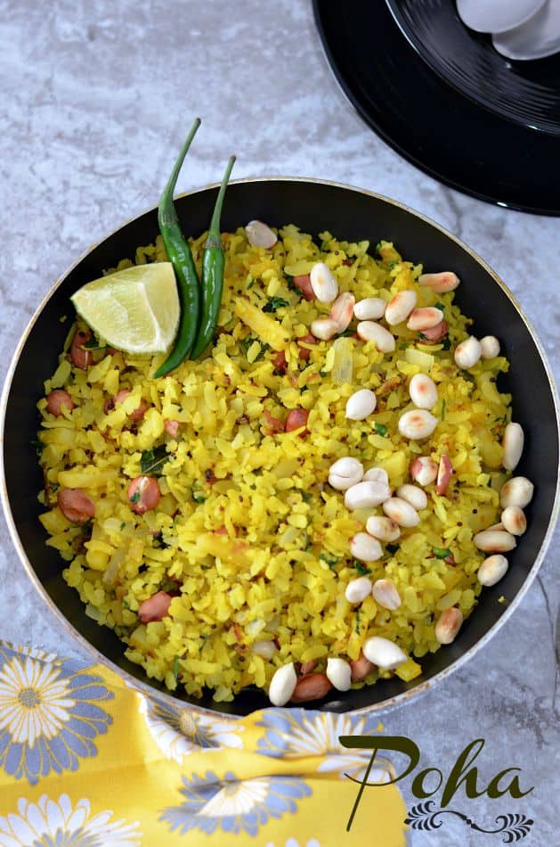 Indori poha recipe which is a famous street food and a staple breakfast in Madhya Pradesh. Indori Poha Sprinkled with sev or bhujiya and served with jalebi is the unique combination which makes it stand out.