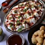 Moong dal dahi vada is a light and delicious Indian street food (Indian chat recipe) made with yellow lentil. Moong dal vadas are deep fried lentil dumplings, soaked in salty water and then served with beaten curd, green chutney, and sweet tamarind chutney.A perfect snack recipe for evening snacks or special occasions or festivals like Holi, Diwali.