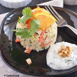 quinoa carrot salad served on a white place with tahini dressing