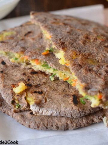 kuttu(buckwheat) flour stuffed paratha iserved with carrots and yogurt during fasting meal.