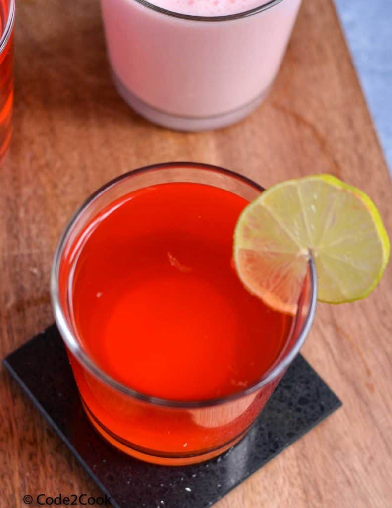 rooh afza lemonade served in a glass & garnish with lemon wedge