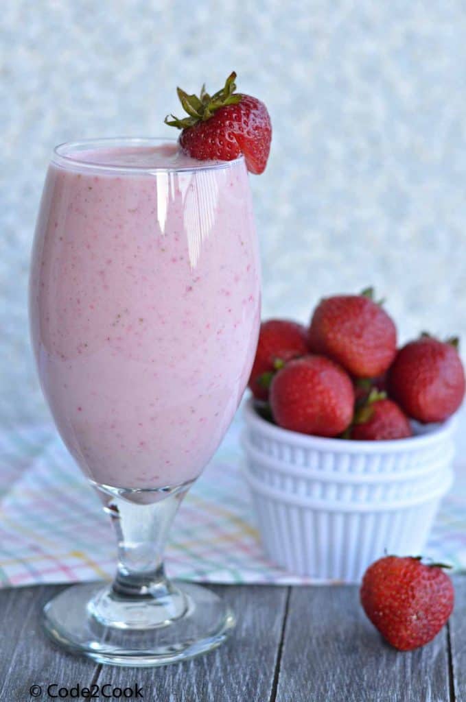 Front click of sugar free strawberry milk served in glass.