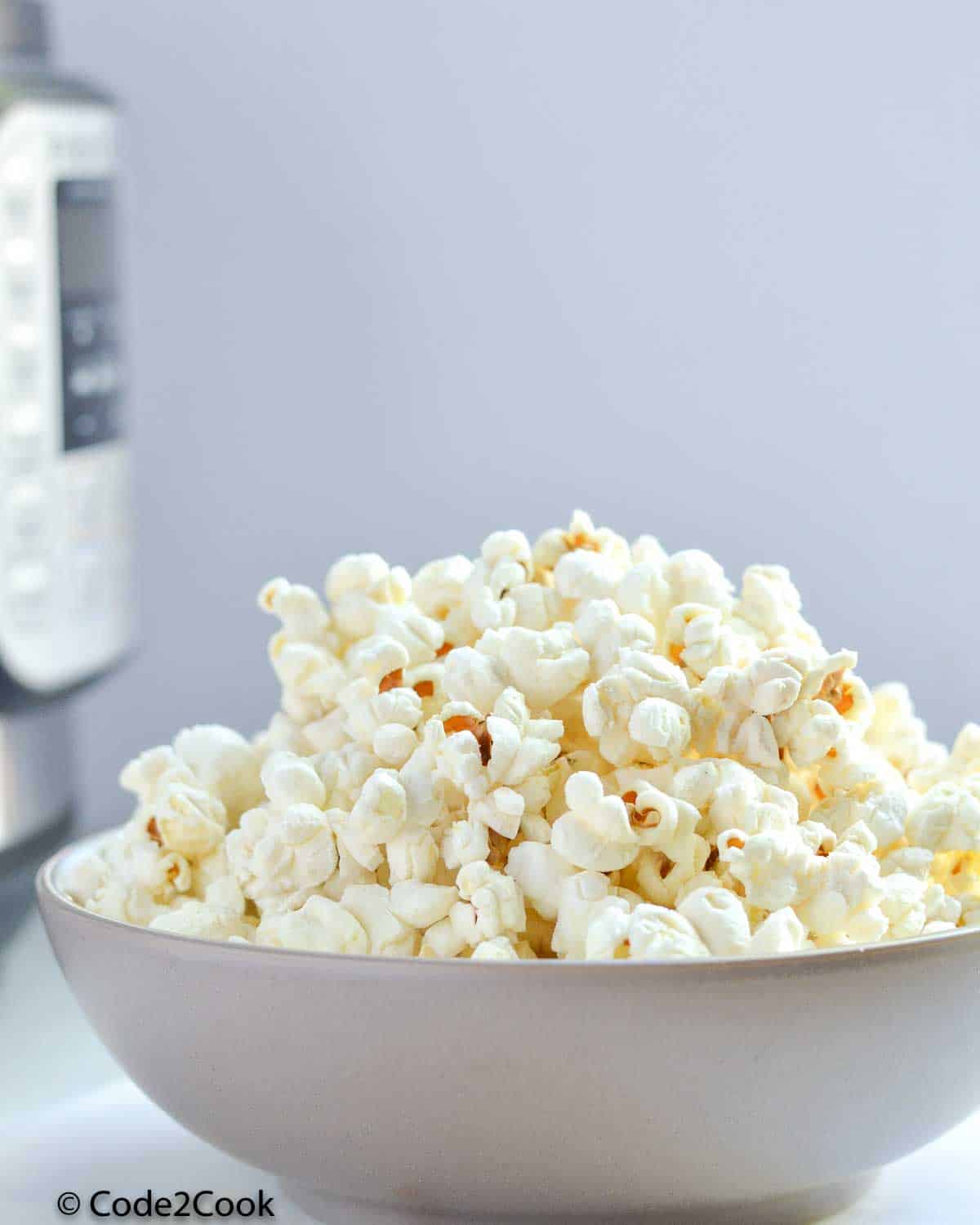 a bowl filled with popcorn made in instant pot.