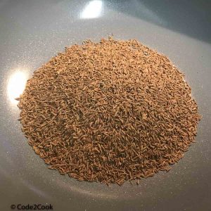cumin seeds added on a heavy bottom pan to dry roast
