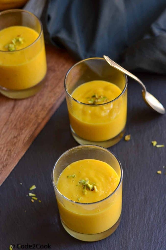 aamras is served in small glasses, garnished with chopped nuts