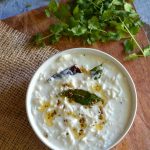 tempered mooli raita served in white bowl.