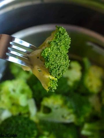 checking doneness of steamed broccoli using fork
